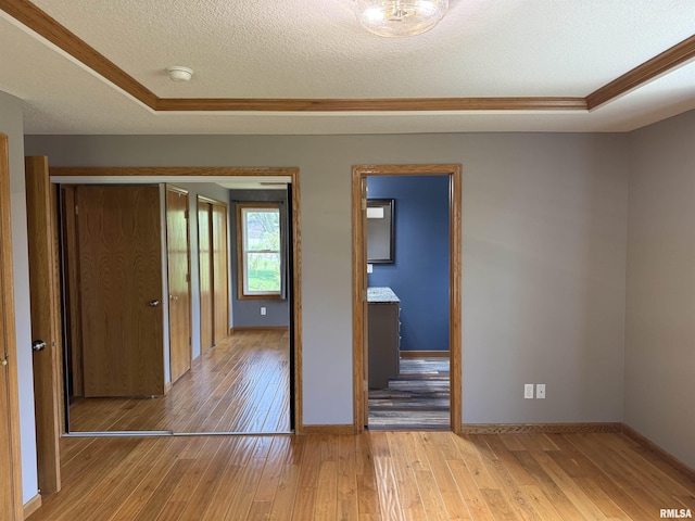 124 Riverview Heights Dr, Le Claire, IA 52753 - unfurnished bedroom featuring ornamental molding, hardwood / wood-style floors, and a textured ceiling