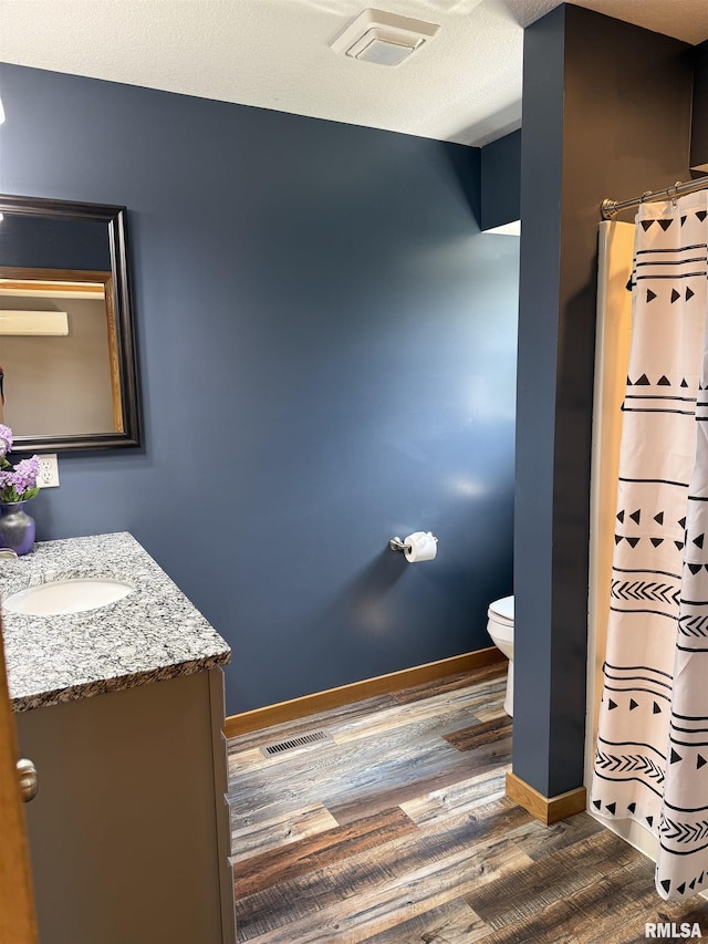 124 Riverview Heights Dr, Le Claire, IA 52753 - full bathroom featuring wood finished floors, vanity, and a shower with curtain