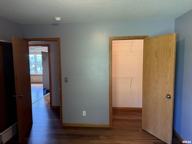 124 Riverview Heights Dr, Le Claire, IA 52753 - corridor featuring wood finished floors and a textured ceiling