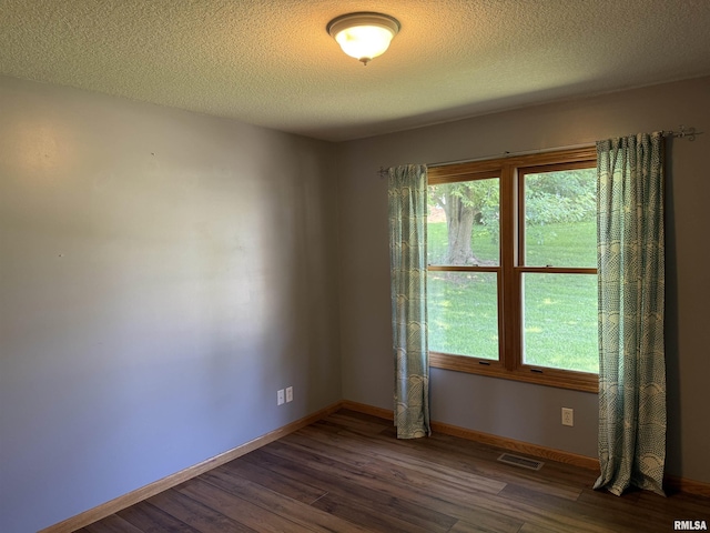 124 Riverview Heights Dr, Le Claire, IA 52753 - empty room featuring dark wood finished floors and a textured ceiling