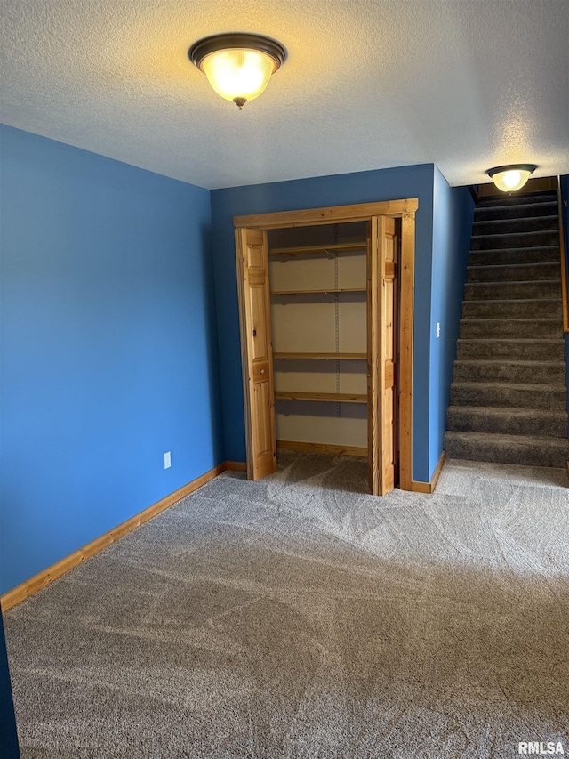 124 Riverview Heights Dr, Le Claire, IA 52753 - unfurnished bedroom with a textured ceiling, carpet flooring, and a closet