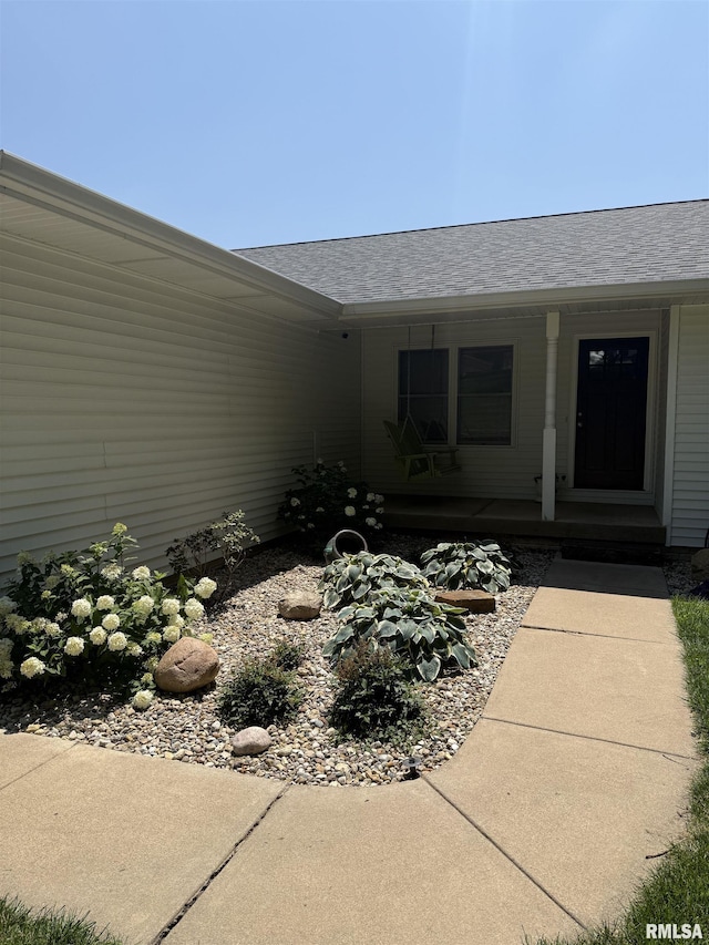 124 Riverview Heights Dr, Le Claire, IA 52753 - view of exterior entry with a porch and roof with shingles