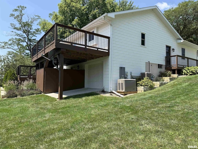 124 Riverview Heights Dr, Le Claire, IA 52753 - rear view of house featuring a wooden deck, a yard, and a garage