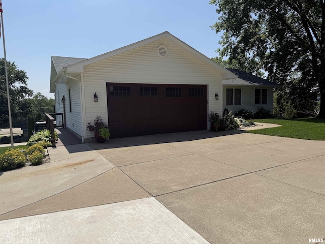 124 Riverview Heights Dr, Le Claire, IA 52753 - view of front of home featuring an attached garage and concrete driveway