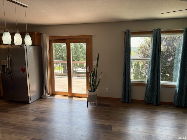124 Riverview Heights Dr, Le Claire, IA 52753 - unfurnished dining area with plenty of natural light and dark wood-style floors