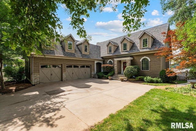 1 S Shore Ln, Rapids City, IL 61278 - new england style home featuring stone siding, concrete driveway, and a garage