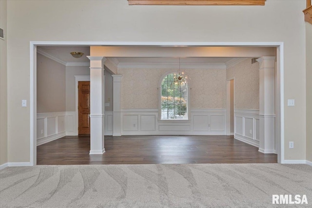 1 S Shore Ln, Rapids City, IL 61278 - carpeted spare room with crown molding, a chandelier, ornate columns, a decorative wall, and wood finished floors