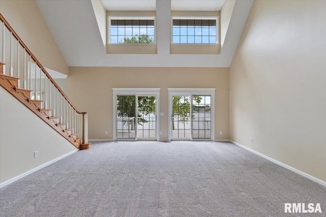 1 S Shore Ln, Rapids City, IL 61278 - unfurnished living room with a high ceiling, carpet floors, and stairs