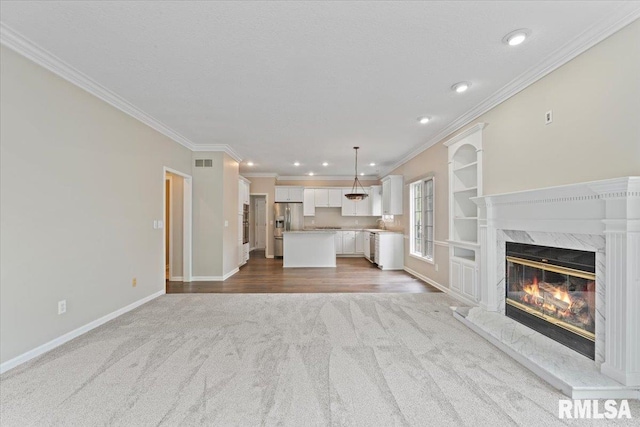 1 S Shore Ln, Rapids City, IL 61278 - unfurnished living room with carpet floors, ornamental molding, a fireplace, and recessed lighting
