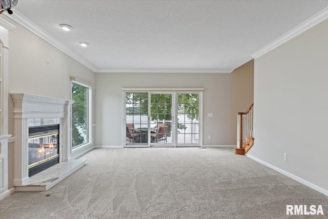1 S Shore Ln, Rapids City, IL 61278 - unfurnished living room with a textured ceiling, ornamental molding, stairs, carpet, and plenty of natural light