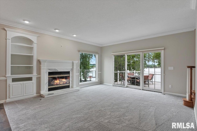 1 S Shore Ln, Rapids City, IL 61278 - unfurnished living room with a premium fireplace, ornamental molding, a textured ceiling, and carpet flooring