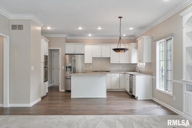 1 S Shore Ln, Rapids City, IL 61278 - kitchen with stainless steel appliances, a kitchen island, white cabinets, crown molding, and pendant lighting