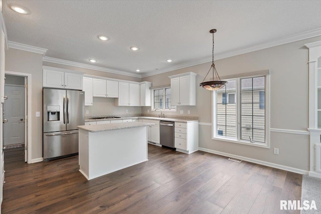 1 S Shore Ln, Rapids City, IL 61278 - kitchen with appliances with stainless steel finishes, dark wood-type flooring, white cabinets, a center island, and ornamental molding