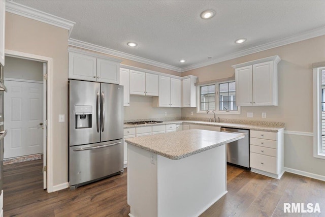 1 S Shore Ln, Rapids City, IL 61278 - kitchen with stainless steel appliances, white cabinets, dark wood finished floors, a center island, and crown molding