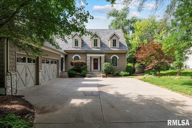 1 S Shore Ln, Rapids City, IL 61278 - new england style home with concrete driveway and an attached garage