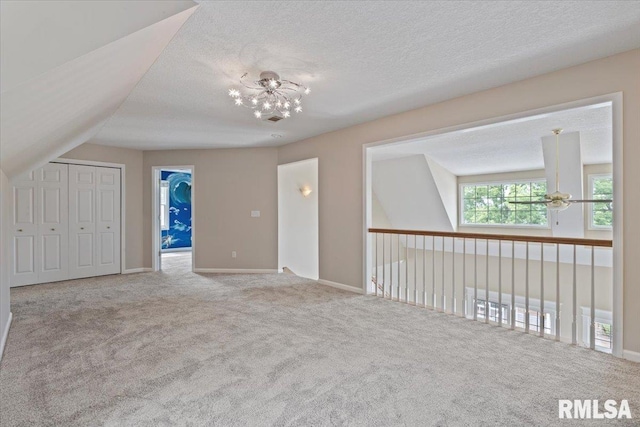 1 S Shore Ln, Rapids City, IL 61278 - additional living space with carpet flooring, a chandelier, and a textured ceiling