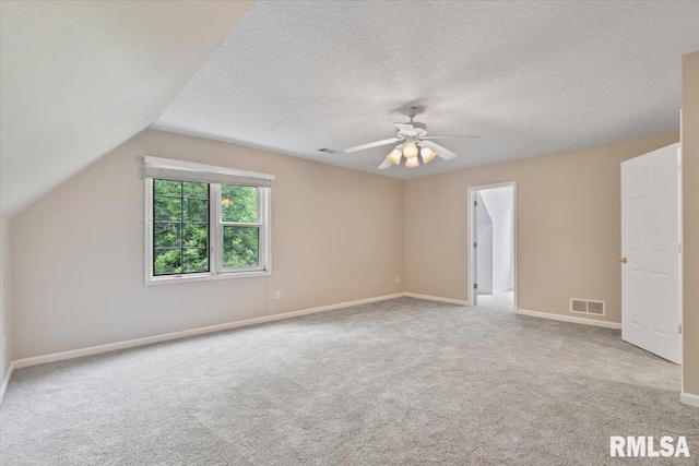 1 S Shore Ln, Rapids City, IL 61278 - unfurnished bedroom featuring carpet flooring, vaulted ceiling, a ceiling fan, and a textured ceiling
