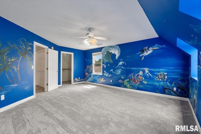1 S Shore Ln, Rapids City, IL 61278 - unfurnished bedroom with carpet floors, a walk in closet, a textured ceiling, and a ceiling fan