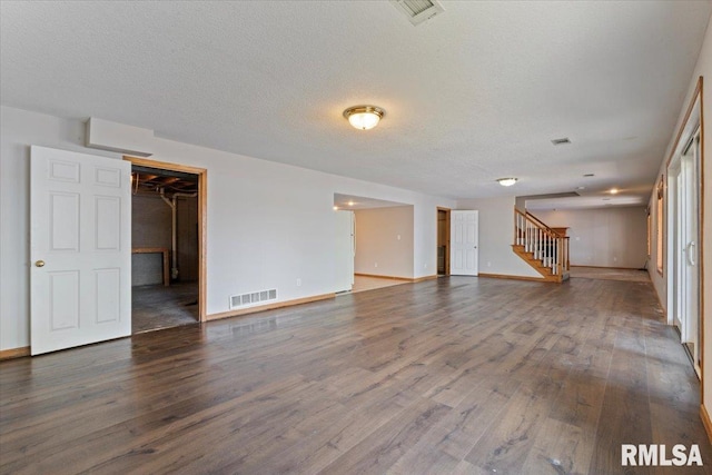 1 S Shore Ln, Rapids City, IL 61278 - unfurnished living room featuring stairs, wood finished floors, and a textured ceiling