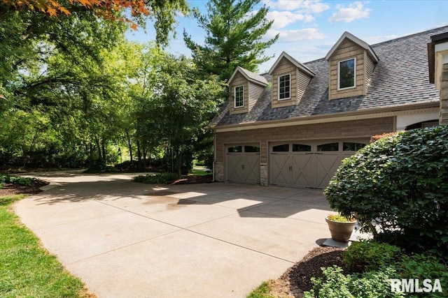 1 S Shore Ln, Rapids City, IL 61278 - view of home's exterior with concrete driveway, roof with shingles, and a garage