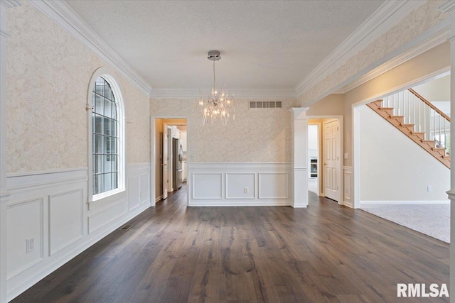 1 S Shore Ln, Rapids City, IL 61278 - unfurnished dining area featuring a chandelier, dark wood finished floors, stairs, wainscoting, and crown molding