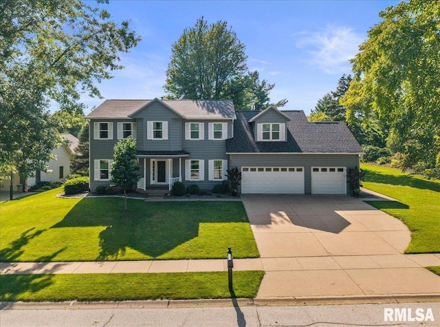 6470 James Rd, Bettendorf, IA 52722 - view of front of house featuring concrete driveway, an attached garage, and a front yard