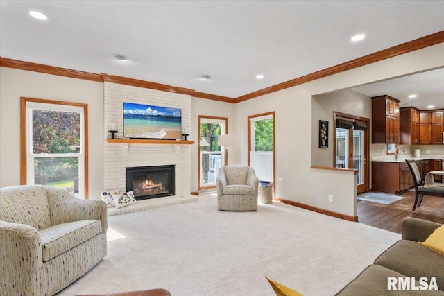 6470 James Rd, Bettendorf, IA 52722 - carpeted living area featuring recessed lighting, ornamental molding, and a brick fireplace