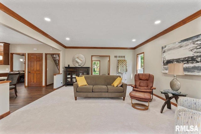 6470 James Rd, Bettendorf, IA 52722 - living room with recessed lighting, dark colored carpet, ornamental molding, and dark wood-style flooring