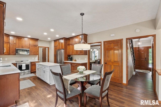 6470 James Rd, Bettendorf, IA 52722 - dining room with dark wood-style floors, recessed lighting, and a chandelier