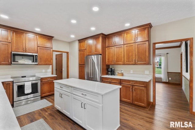 6470 James Rd, Bettendorf, IA 52722 - kitchen with appliances with stainless steel finishes, brown cabinets, dark wood-style flooring, light countertops, and recessed lighting