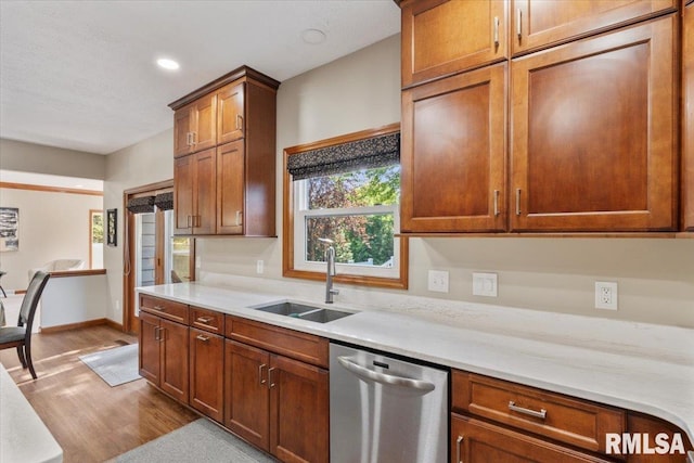 6470 James Rd, Bettendorf, IA 52722 - kitchen featuring dishwasher, wood finished floors, light countertops, recessed lighting, and brown cabinetry