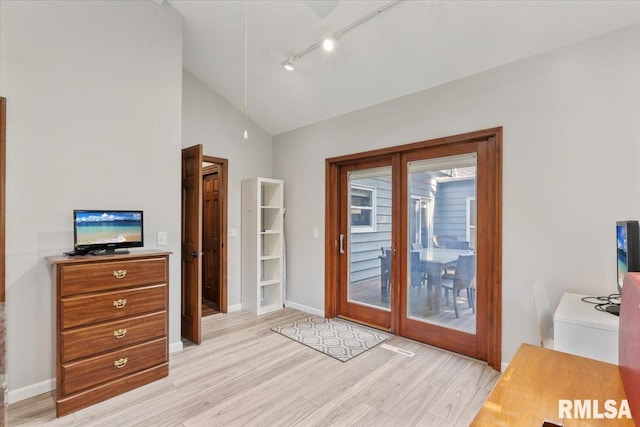 6470 James Rd, Bettendorf, IA 52722 - bedroom featuring access to exterior, light wood-style flooring, rail lighting, and high vaulted ceiling