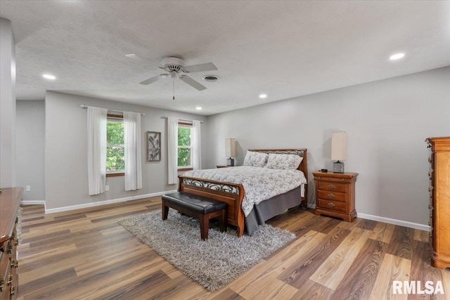 6470 James Rd, Bettendorf, IA 52722 - bedroom featuring wood finished floors, recessed lighting, and a ceiling fan