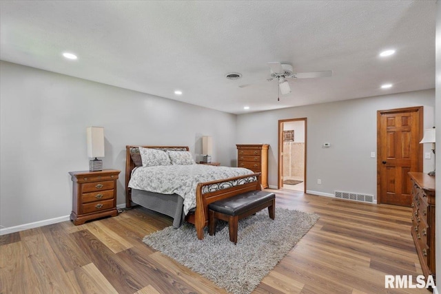 6470 James Rd, Bettendorf, IA 52722 - bedroom with wood finished floors, recessed lighting, ensuite bathroom, and a ceiling fan