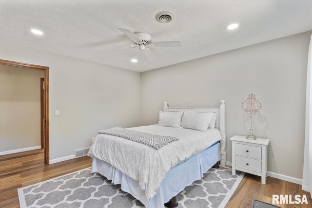 6470 James Rd, Bettendorf, IA 52722 - bedroom featuring wood finished floors, ceiling fan, and recessed lighting