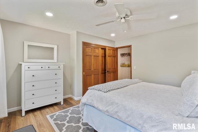 6470 James Rd, Bettendorf, IA 52722 - bedroom featuring light wood-type flooring, recessed lighting, a closet, and ceiling fan