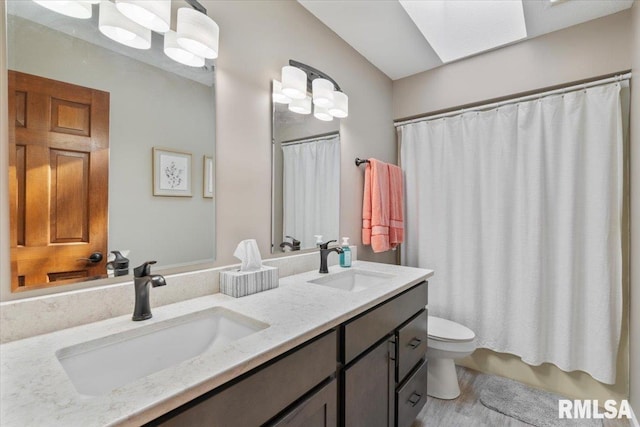 6470 James Rd, Bettendorf, IA 52722 - full bathroom featuring double vanity and wood finished floors