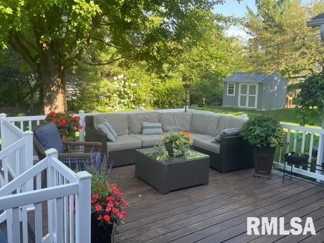 6470 James Rd, Bettendorf, IA 52722 - wooden deck featuring an outdoor hangout area, a storage unit, and view of scattered trees