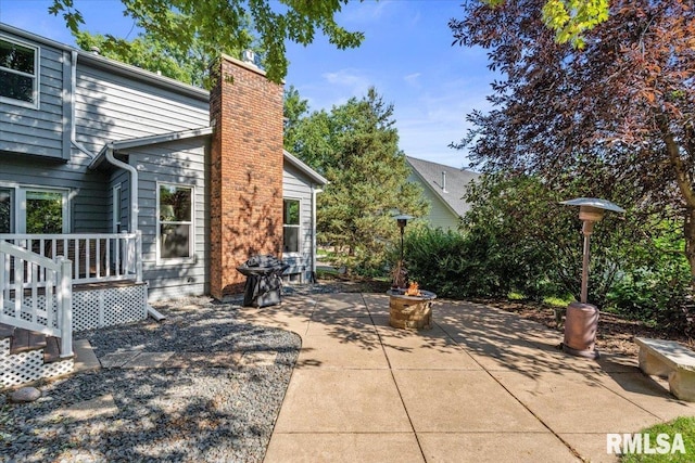 6470 James Rd, Bettendorf, IA 52722 - view of patio with a fire pit