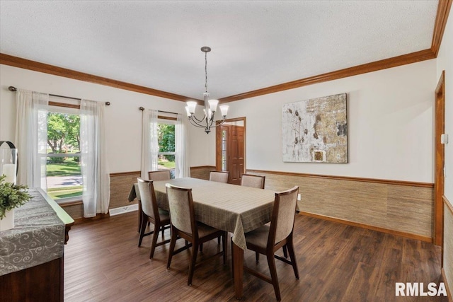 6470 James Rd, Bettendorf, IA 52722 - dining room with wainscoting, a chandelier, crown molding, and dark wood-type flooring