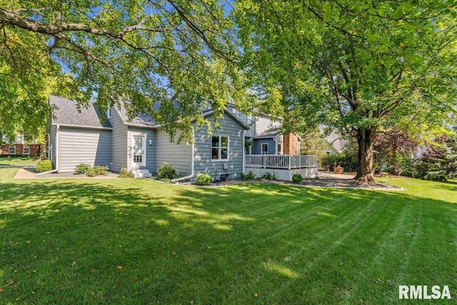 6470 James Rd, Bettendorf, IA 52722 - back of property with a lawn and a deck