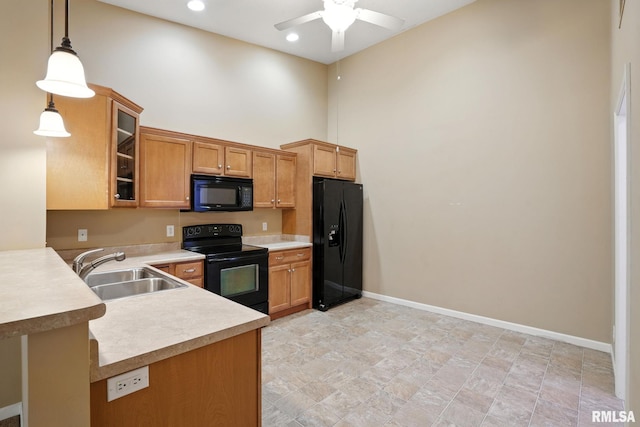 2997 3rd St Unit 206, Moline, IL 61265 - kitchen featuring a ceiling fan, black appliances, a towering ceiling, light countertops, and pendant lighting
