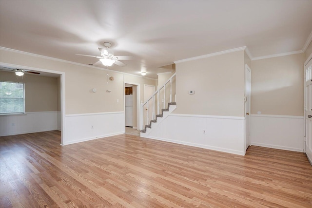 spare room with light wood-type flooring, ceiling fan, and crown molding