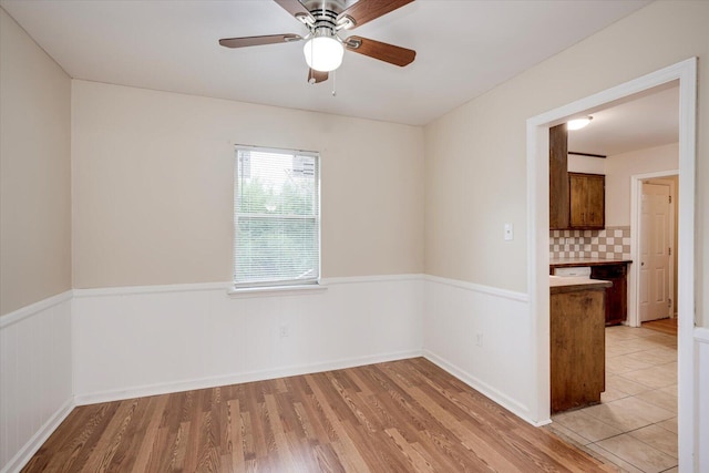 unfurnished room featuring ceiling fan and light hardwood / wood-style floors