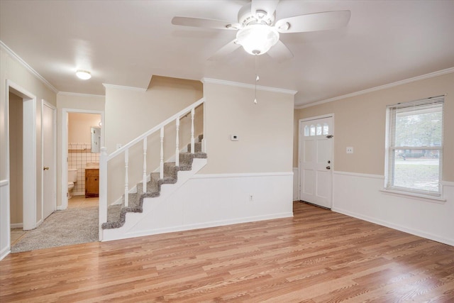 entryway featuring ceiling fan, light wood-type flooring, and ornamental molding