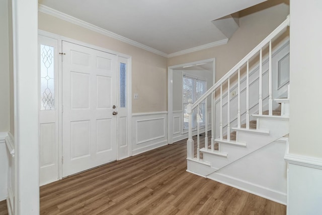 foyer featuring ornamental molding and hardwood / wood-style flooring