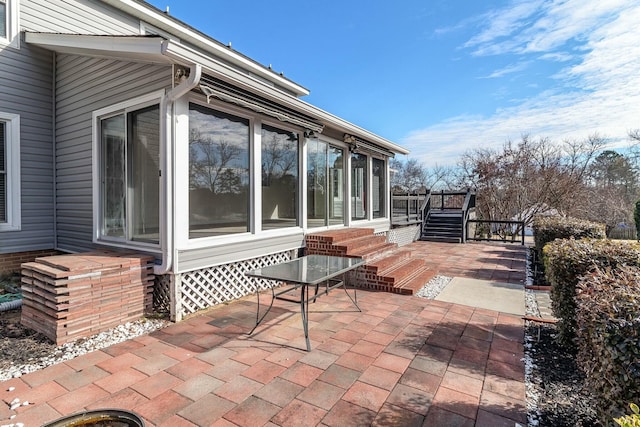 view of patio with a sunroom