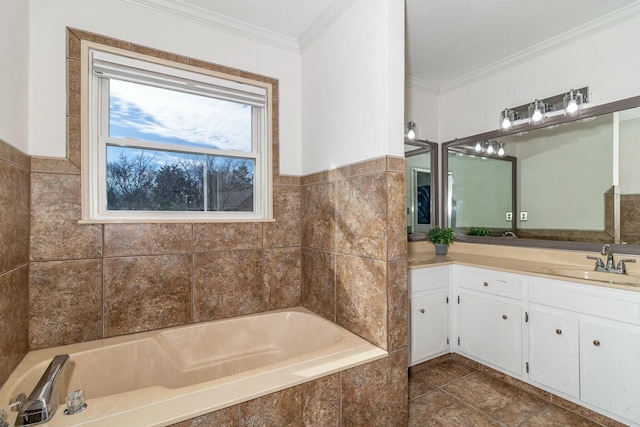 bathroom featuring tiled bath, crown molding, and vanity