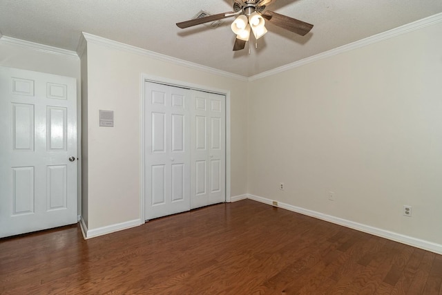 unfurnished bedroom featuring ceiling fan, dark hardwood / wood-style floors, a closet, and ornamental molding