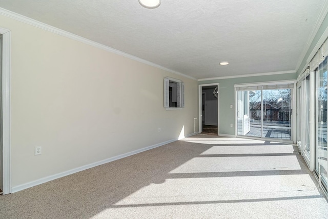 spare room featuring light carpet, crown molding, and a textured ceiling